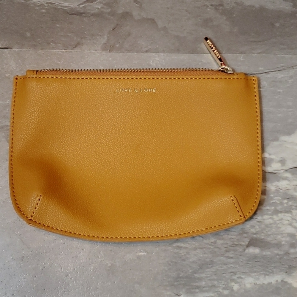 NWOT Love & Lore small thin zip pouch. Vegan leather (faux). Tan/mustard yellow.